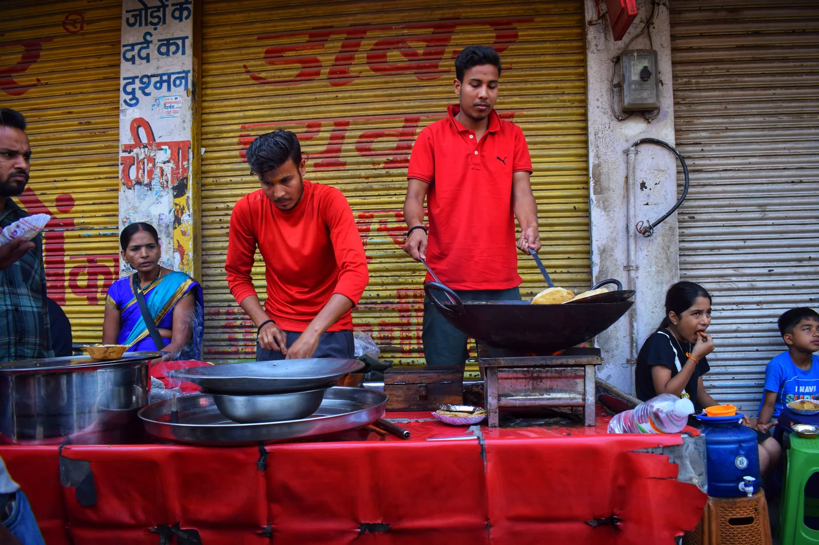 A vendor preparing kachori sabzi at a street food stall in Varanasi