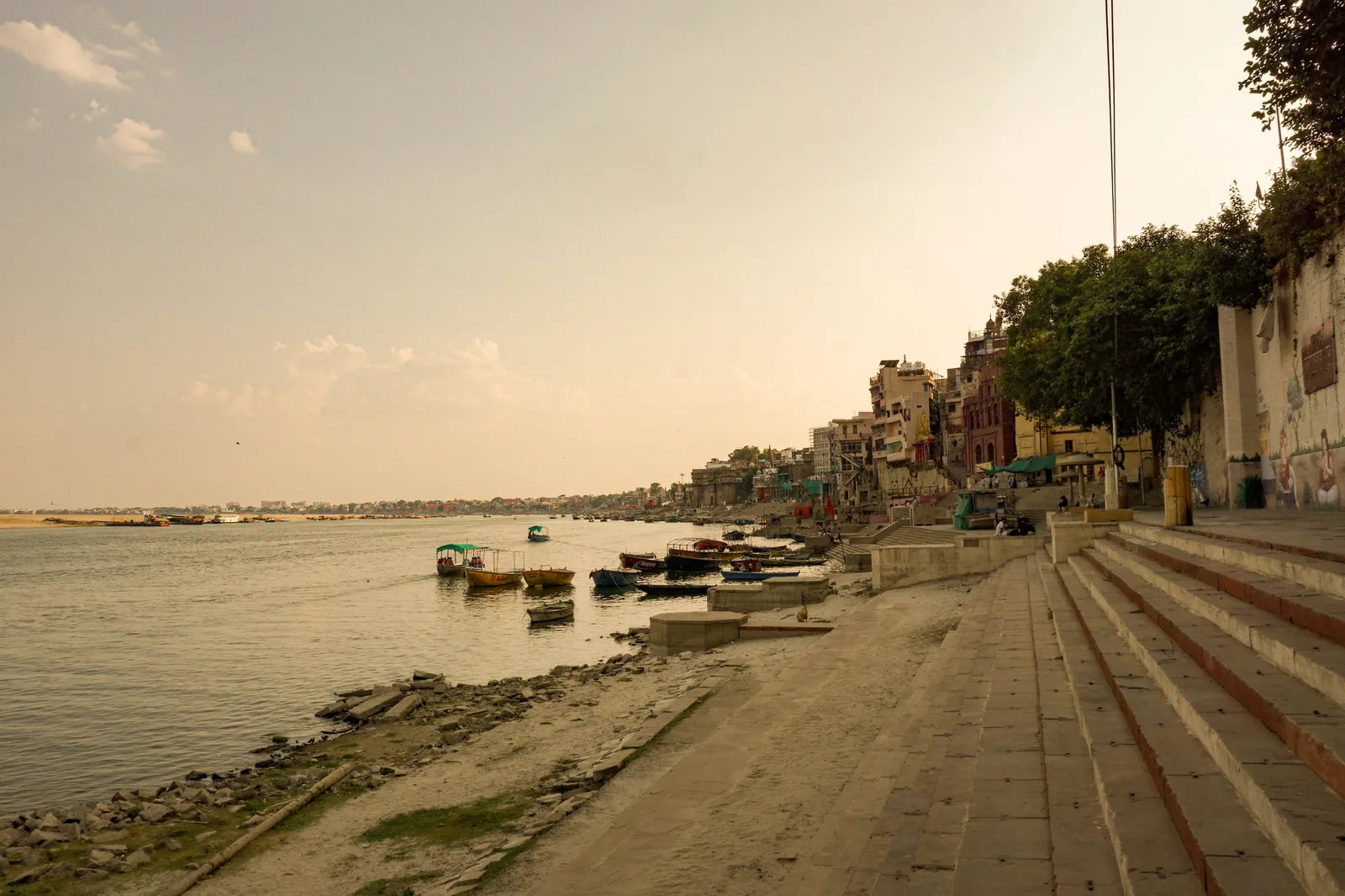 View of the ghats and temples along the Ganges river in Varanasi at golden hour